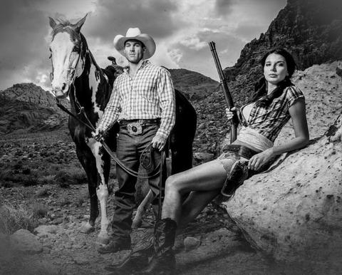 man with horse and woman with gun